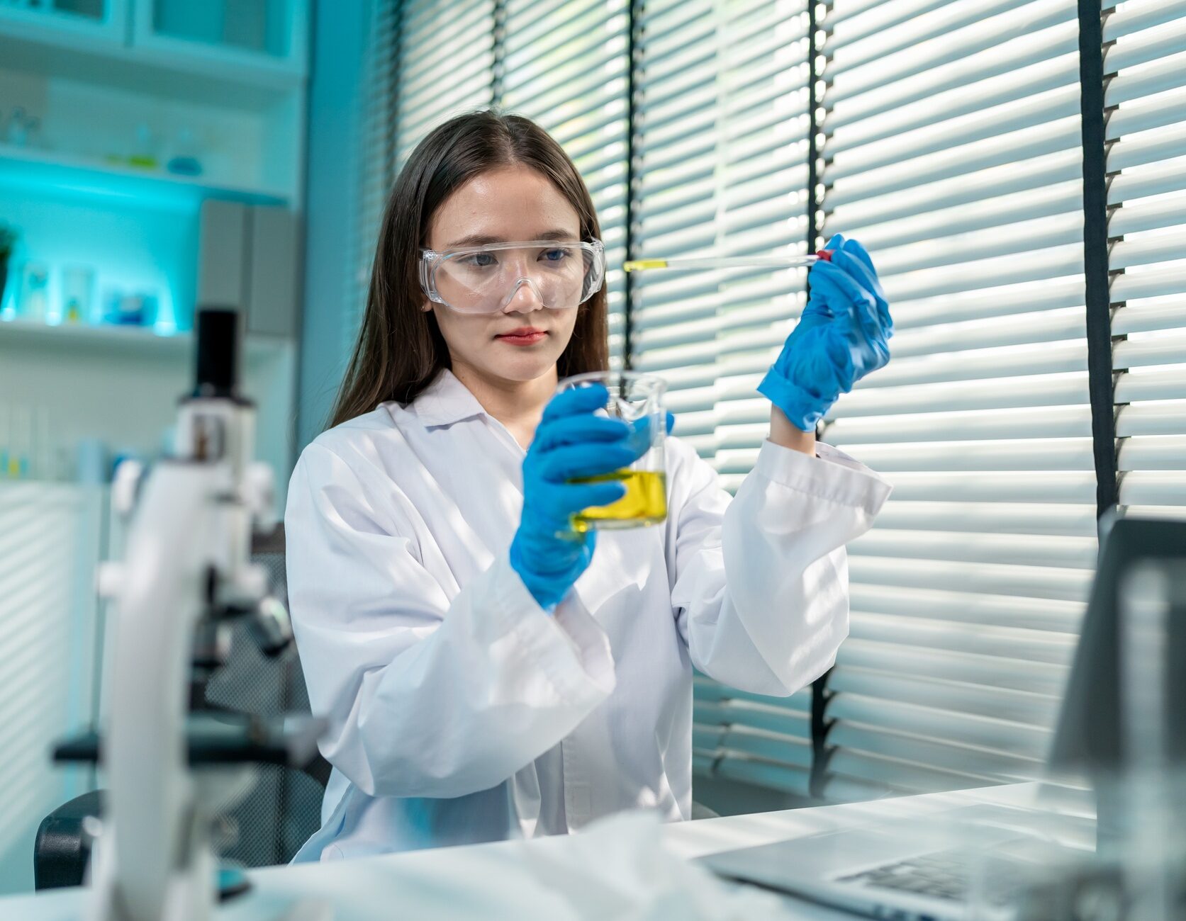 Asian female scientist working in biotechnology research laboratory. A